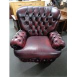 A Burgundy leather Chesterfield style armchair