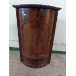 A nineteenth century corner cabinet fitted a drawer