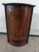 A nineteenth century corner cabinet fitted a drawer