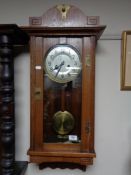 An Edwardian oak Arts and Crafts wall clock with silvered dial CONDITION REPORT: 85