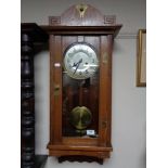 An Edwardian oak Arts and Crafts wall clock with silvered dial CONDITION REPORT: 85