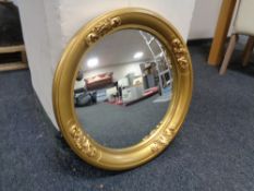 An antique gilt framed circular mirror