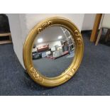 An antique gilt framed circular mirror