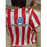 A signed Sunderland football shirt (with retail tags)