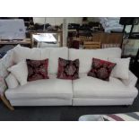 A good quality four seater settee in cream fabric with scatter cushions (un-used)