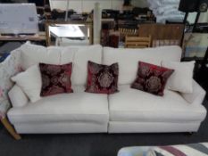 A good quality four seater settee in cream fabric with scatter cushions (un-used)