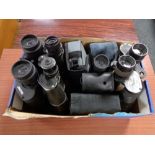 A box of a quantity of binoculars and monoculars