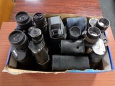 A box of a quantity of binoculars and monoculars