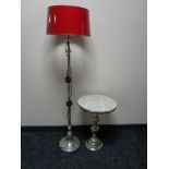 A contemporary metal lamp table together with a floor lamp with red shade