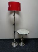 A contemporary metal lamp table together with a floor lamp with red shade