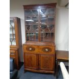 An early nineteenth century inlaid mahogany secretaire bookcase,