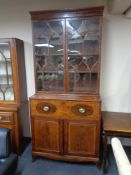 An early nineteenth century inlaid mahogany secretaire bookcase,