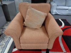 A red fabric armchair with cushion