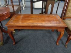 A carved hardwood inlaid brass occasional table