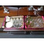Two crates of wine glasses, gilded dinner ware, storage containers,