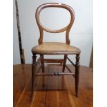 An antique bergere bedroom chair