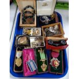 A tray of costume jewellery, pocket watch, enamelled medals,