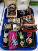 A tray of costume jewellery, pocket watch, enamelled medals,