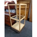 A beech framed glass shop display stand