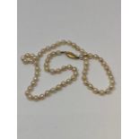 A cultured pearl necklace on 9ct gold clasp, approximate pearl diameter 5mm, length 45 cm.