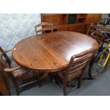 A circular pine ducal pedestal dining table and four chairs