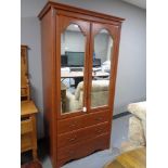 A contemporary mirror door wardrobe fitted with three drawers