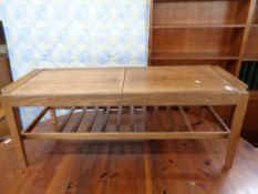 A mid century teak sliding storage low table