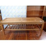 A mid century teak sliding storage low table