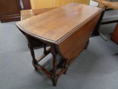 An early twentieth century oak gate-legged leg dining table.