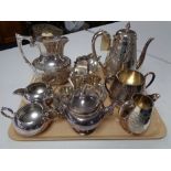 A three piece silver plated tea service, together with various other plated wares, teapot,