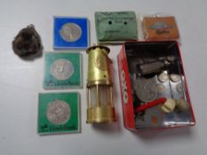 An Oxo tin containing crowns, coins, miniature brass lamp,