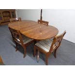 An inlaid yewwood oval dining table together with four chairs