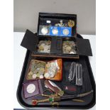 A tray of antique metal cash box, letter opener, large quantity of foreign coins, military badges,