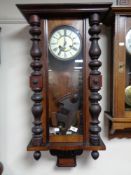 An early twentieth century mahogany eight day wall clock with brass and enamelled dial