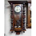 An early twentieth century mahogany eight day wall clock with brass and enamelled dial