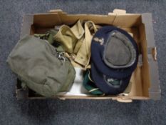 A box of military caps, canvas bag, cricket cap,