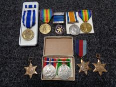 Three WW I medals together with WW II medals and others.