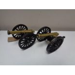 A pair of brass and metal cannons