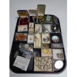 A tray of costume jewellery, brooches,
