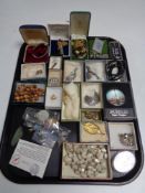 A tray of costume jewellery, brooches,