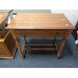 An Edwardian oak side table fitted with a drawer
