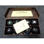 A set of early twentieth century Banda carpet bowls with instructions and case
