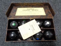 A set of early twentieth century Banda carpet bowls with instructions and case