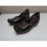 A pair of Victorian leather studded child's clogs, stamped J. Percival.