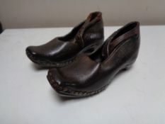 A pair of Victorian leather studded child's clogs, stamped J. Percival.