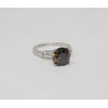 A platinum diamond solitaire ring, the cognac-brown brilliant-cut diamond weighing 3.