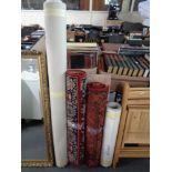Two Easter design machine made carpet runners together with a roll of vinyl, piece of pink marble,