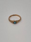 An antique yellow metal ring set with turquoise, size N, 1.4g.