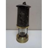 An early twentieth century brass protector miner's lamp