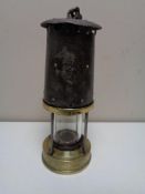 An early twentieth century brass protector miner's lamp